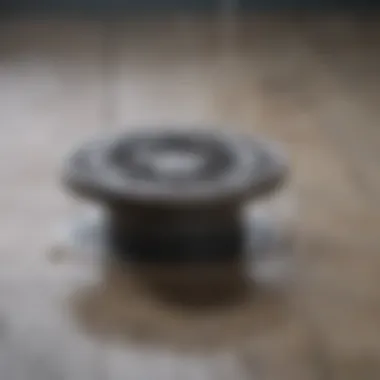 A close-up view of a clogged shower drain with water pooling around it