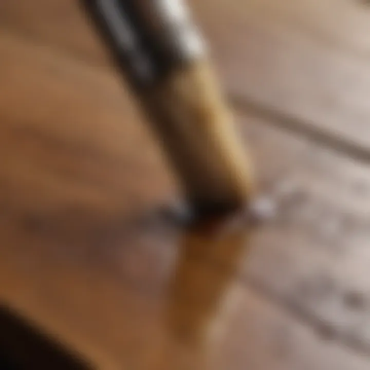 Close-up of a brush applying a natural oil stain on a wooden surface