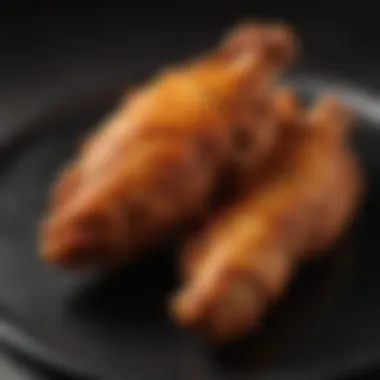 A golden-brown air fried chicken wing, showcasing texture.