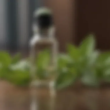 A small glass bottle filled with clear peppermint oil, with fresh peppermint leaves in the background.