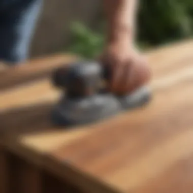 Detail of a palm sander being used on a deck corner